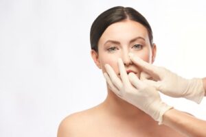 Doctor in gloves touch woman face.