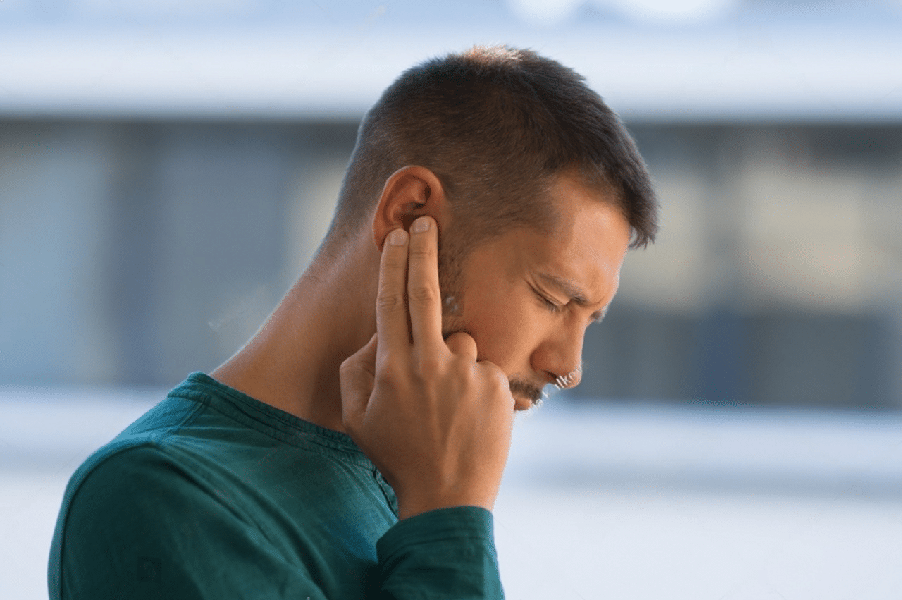 Man dealing with ear pain from ear infection